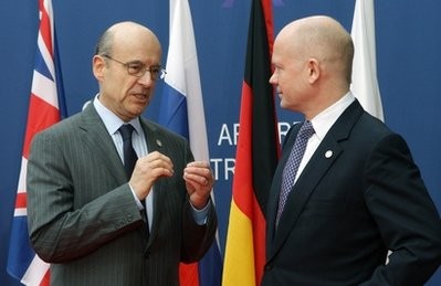France's Foreign Minister Alain Juppe, left, gestures as he welcomes Britain's Foreign Minister William Hague, right, for a Group of Eight Foreign Ministers meeting in Paris, Tuesday, March 15, 2011