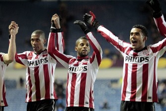 PSV Eindhoven's Brazilian defender, Marcelo (L) celebrates with Jeremain Lens (2-L) and Abel Tamata after winning 1-0 against Rangers. AFP