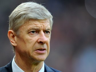 Arsenal's manager Arsene Wenger looks on before the FA Cup quarter-final against Manchester United on March 12, 2011. AFP