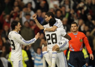 Real Madrid's Angel di Maria (top) celebrates with team mates after scoring a goal during the Champions League match Real Madrid vs Olympique Lyonnais at Santiago Bernabeu Stadiun in Madrid on March 16, 2011. Madrid won 3-0. AFP