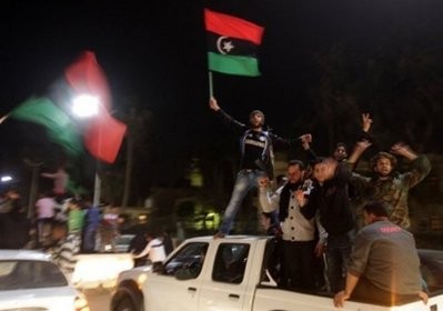 Libyan rebels celebrate in Benghazi last night after the United Nations Security Council voted to impose a no-fly zone over Libya. AFP