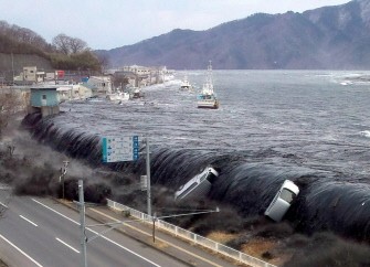 This picture taken by a Miyako City official on March 11, 2011 shows a tsunami breeching an embankment and flowing into the city of Miyako in Iwate prefecture. AFP