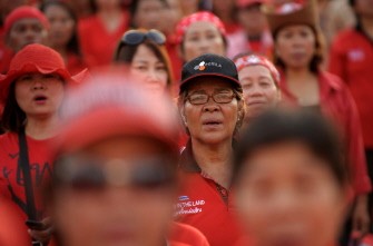 Thai anti-government 'Red Shirt' protesters sing the national anthem during a rally in downtown Bangkok on March 19, 2011. AFP