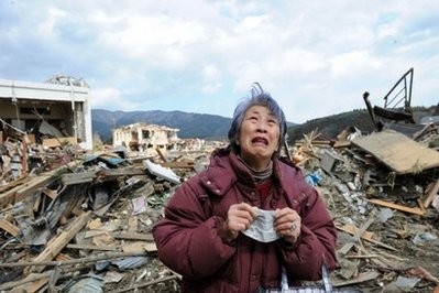 AFP - An elderly woman cries in front of a destroyed building in the devastated town of Rikuzentakata in Iwate prefecture.