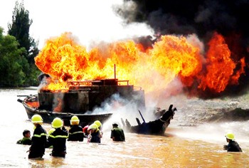 Firefighters extinguishing the burning vessel (Photo: SGGP)