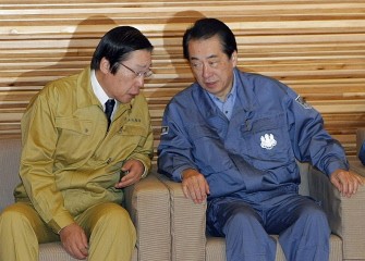 Japanese Prime Minister Naoto Kan (R) talks to Agriculture Minister Michihiko Kano at a cabinet meeting at Kan's office in Tokyo on March 22, 2011. Japan has ordered a halt to shipments of certain foods from four prefectures after abnormal radiation levels were found in products near a quake-hit nuclear plant. AFP