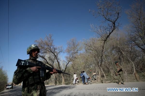 An Afghan Army soldier stands guard at a security checkpoint outside the city of Herat, Afghanistan, March 22. 2011.