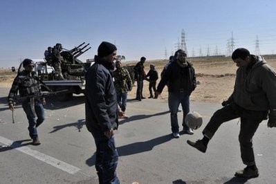 AFP - Libyan rebels play football at the last check point before the strategic eastern town of Ajdabiya.
