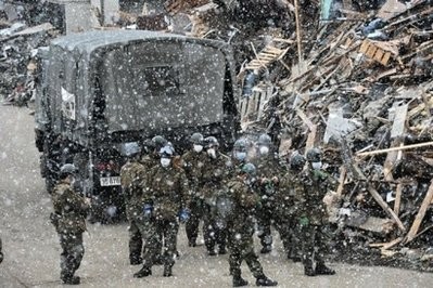 AFP - Members of the Japanese Self-Defense Forces gather for a briefing in the snow in Tarou, north of Morika, in Iwate prefecture, 12 days after the devastating earthquake and tsunami.