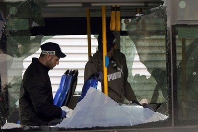 AFP - Israeli security forces inspect the scene of an explosion on a bus near Jerusalem's central bus station.