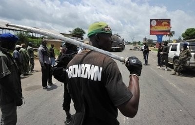 AFP - Militiamen backing internationally recognised president Alassane Ouattara man a makeshift checkpoint in the Abobo district of Abidjan.