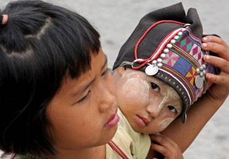 Myanmar children rest at a market in Tachileik near the Thai-Myanmar border on March 26, 2011. AFP