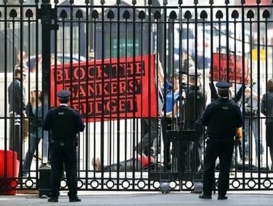 AFP file - British police look on while demonstrators block the main gate to Downing Street on March 23.