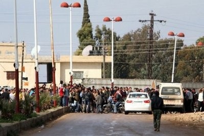 Hundreds of Syrian protesters gather in the village of Ghabagheb to walk towards the restive city of Daraa, south of Damascus, in a solidarity protest on March 25.