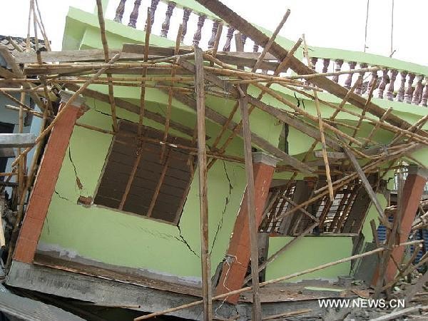 A damaged house is seen in Tarley, Myanmar, March 25, 2011