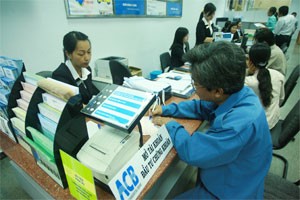 An investor registers to open a stock trading account at a HCMC-based branch of Asia Commercial Bank. Investors are struggling to make investments this year as the major investment classes are being frozen (Photo:Minh Tri)