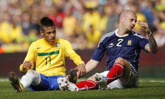 Brazil's Neymar (L) gestures with Scotland's Alan Hutton during their friendly football match at the Emirates Stadium in London. AFP