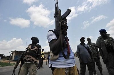 Militiamen backing internationally recognised president Alassane Ouattara man a makeshift checkpoint in the Abobo district of Abidjan.