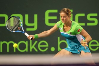 AFP - Kim Clijsters hits a forehand return against Ana Ivanovic of Serbia on March 29, 2011