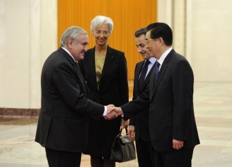 Chinese President Hu Jintao (R) shakes hands with former French prime minister Jean-Pierre Raffarin (L) as French counterpart Nicolas Sarkozy (2R) and French Finance and Economy Minister Christine Lagarde (2L) look on as they meet for a working meeting at the Great Hall of the People in Beijing on March 30, 2011. Sarkozy arrived in China on March 30 at the start of an Asian mini-tour that will include a G20 seminar on the world monetary system and a stop in disaster-struck Japan. AFP