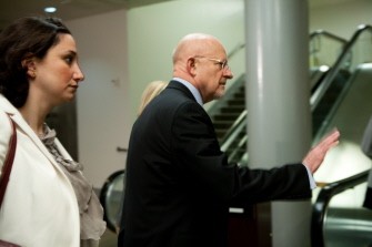 AFP - National Intelligence Director James Clapper (C) leaves a briefing for Senators in the U.S. Capitol on March 30, 2011 in Washington, DC.