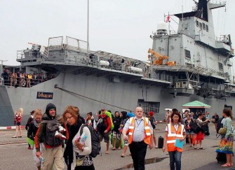 AFP - Foreign tourists disembark from a Thai Navy aircraft carrier at Sattahip naval base, some 150 kms southeast of Bangkok, on March 31, 2011 after around 700 of them were evacuated from Ko Tao island, in the Gulf of Thailand