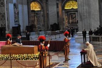 AFP - Pope Benedict XVI (R) prays at the coffin of late pope John Paul II after the ceremony of beatification of John Paul II on May 1, 2011 at St Peter's square at The Vatican.