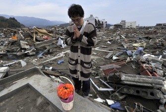 AFP - Atsushi Shibata prays for his mother who died in the March 11 tsunami in the devastated town of Rikuzentakata in Iwate prefecture on May 1, 2011.