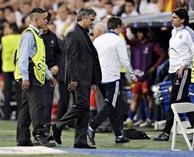 AFP - Real Madrid's coach Jose Mourinho (C) leaves the field after being sent to the stands during his side's match against Barcelona at the Santiago Bernabeu stadium in Madrid on April 27.