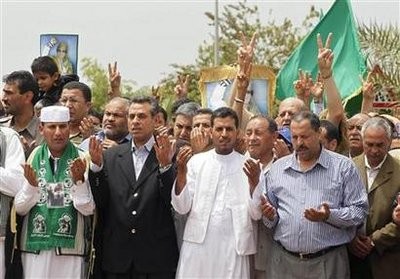 Libyans pray during the funeral of Saif Al-Arab Gaddafi, son of Libyan leader Muammar Gaddafi, who was killed after air strikes by coalition forces last Saturday, at the El Hani cemetery in Tripoli May 2, 2011.