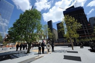 AFP - US President Barack Obama pauses with first responders after laying a wreath at the 9/11 Memorial at Ground Zero in New York