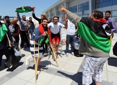 AFP - Wounded Libyan rebels arrive at the airport Tunis-Carthage for treatment from Benghazi.