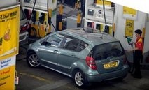 AFP file photo shows a petrol station worker preparing to fill up a car in Hong Kong.