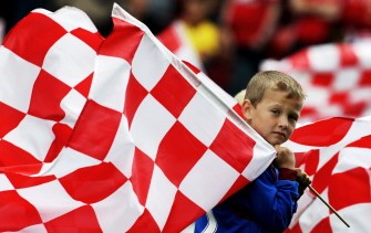 AFP - A young Stoke City fan holds on to a flag ahead of the game against Arsenal during the game