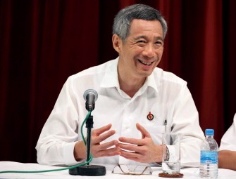 AFP - Singapore's Prime Minister Lee Hsien Loong smiles as he speaks during a press conference early on May 8, 2011, after the ruling People's Action Party won 81 of the 87 parliament seats.