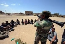 Libyan youths listen to instructions from a rebel on how to use a Rocket Propeled Grenade (RPG)