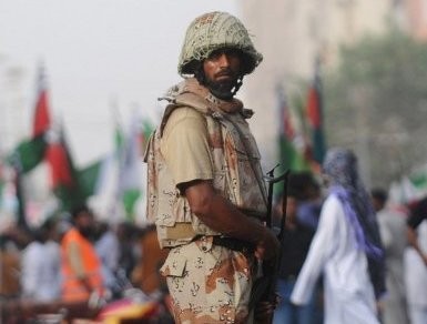 A Pakistan paramilitary soldier stands guard during a protest over the slaying of Al-Qaeda chief Osama bin Laden in Karachi