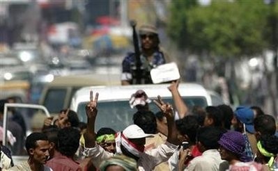 Anti-government protesters surround a police patrol trying to disperse them during a protest to demand the ouster of Yemen's President Ali Abdullah Saleh in the southern city of Taiz May 8, 2011