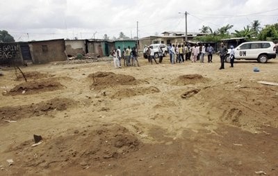 In this Friday, May 6, 2011 photo released by the United Nations Operation in Ivory Coast (known by it's french acronym ONUCI), U.N. investigators visit the site of an alleged mass grave in a recently pacified area of the Yopougon district, in Abidjan, Ivory Coast.