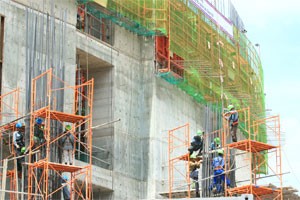 Workers at a construction site in HCMC. Construction firm VNECO grapples with large debts to collect and high expenses of constructions in progress (Photo:Minh Tri)