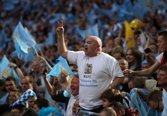 Manchester City fans support their team during the FA Cup final football match between Manchester City and Stoke City