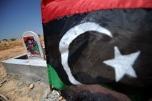Libyan revolution flag at the grave of a rebel fighter at the Alhawari cemetery in rebel's stronghold