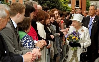 AFP - Britain's Queen Elizabeth II (2-R) smiles as she is greeted by well-wishers, as she leaves Trinity College in Dublin.
