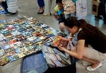 File photo Chinese select latest pirated DVDs on sale at a subway in Beijing, 21 August 2007
