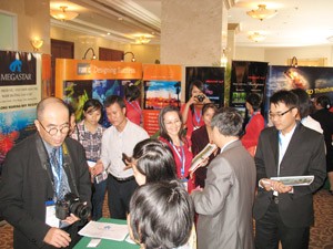 Visitors at the theme parks exhibition that is part of the conference (Photo: Tuong Thuy)