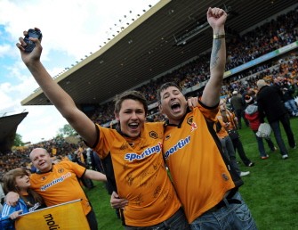 AFP - Wolverhampton Wanderers' fans celebrate on the pitch after the English Premier League football match between Wolverhampton Wanderers and Blackburn Rovers
