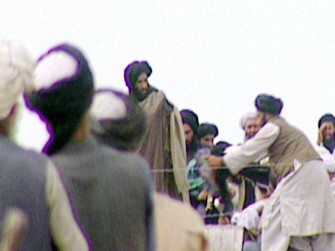 (AFP - FILES) This file photo taken in 1996 of a TV screen grab taken secretly by BBC Newsnight shows Taliban's spiritual leader Mullah Mohammed Omar (C) during a rally of his troops in Kandahar