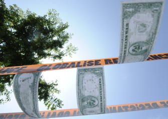 AFP - Fake bank notes are hung during a demonstration, on May 21, 2011 in Le Havre, northwestern France, to denounce the next G8 summit
