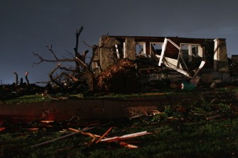 AFP - A damaged home is seen surrounded by debris from other homes after 116 people where killed when a massive tornado passed through the town on May 23, 2011 in Joplin