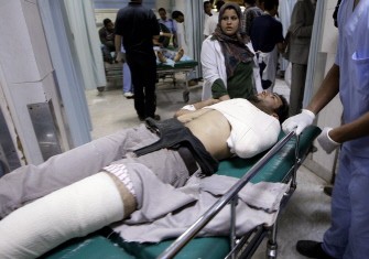 AFP - Medics wheel a Libyan man at the al-Zawiya hospital in Tripoli on May 24, 2011
